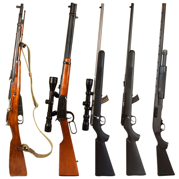 Assortment of hunting rifles stood up on end in a row