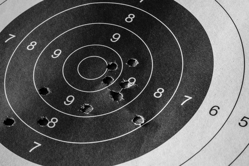Target practice bulls-eye sheet with bullet holes