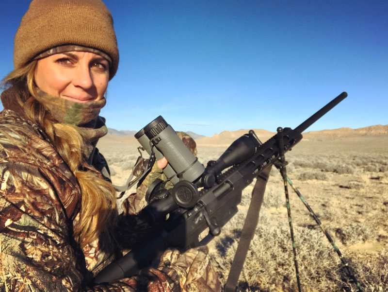 How to Hire a Hunting Guide or Outfitter - Woman in camo laying in field with scoped Remington rifle