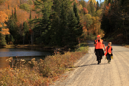 Father and son wearing hunter safety orange vests