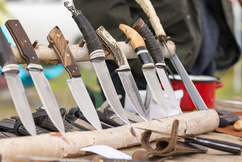 Row of stainless steal hunting knives