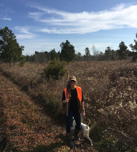 Female hunter in Orange hunting Vest